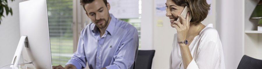 Male and female project manager collaborating in front of computer screen at office, Fast Forward Procurement