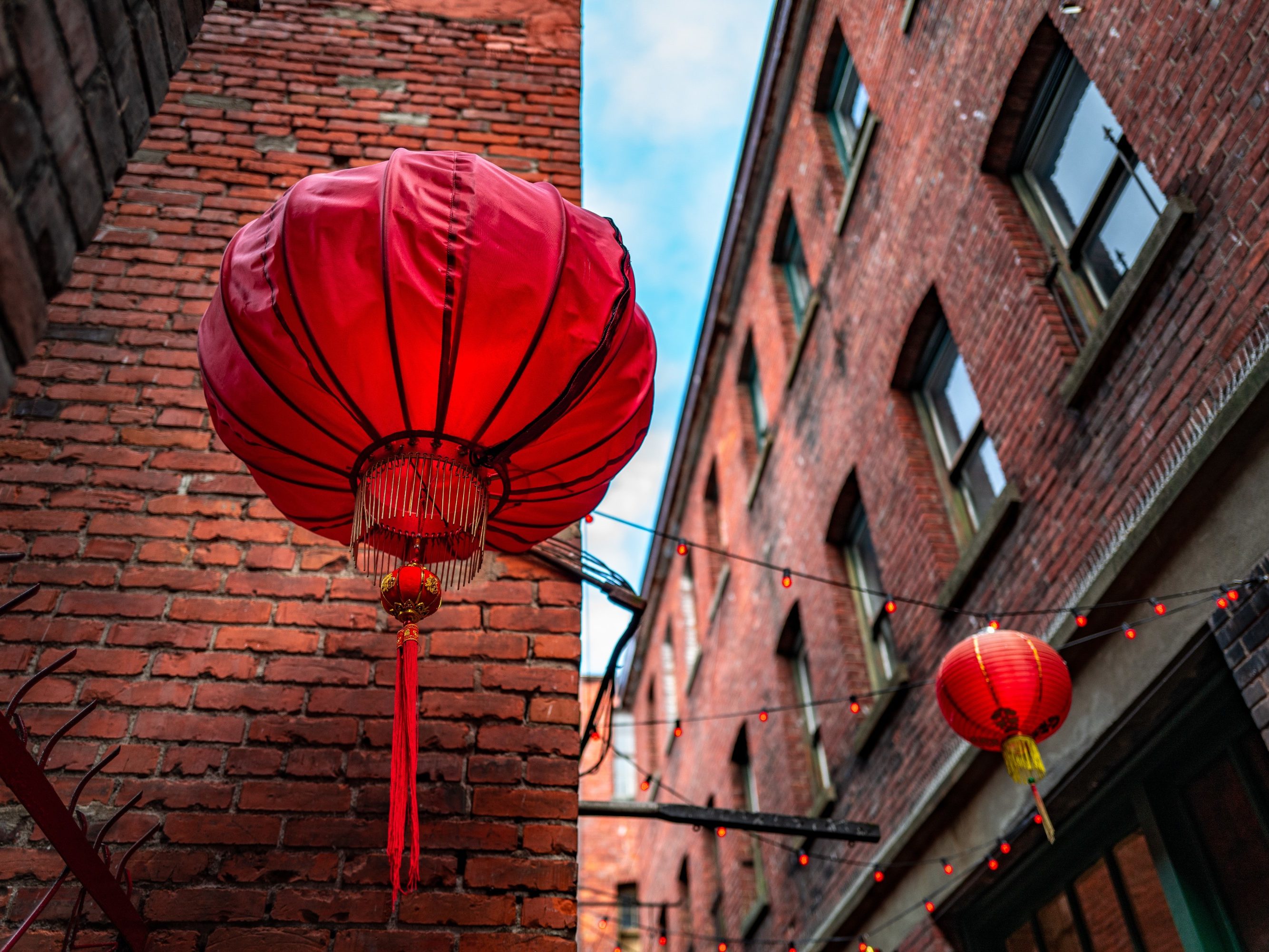 A low angle shot of Chinese lanterns in Fan Tan Alley, Chinatown, Victoria, BC Canada