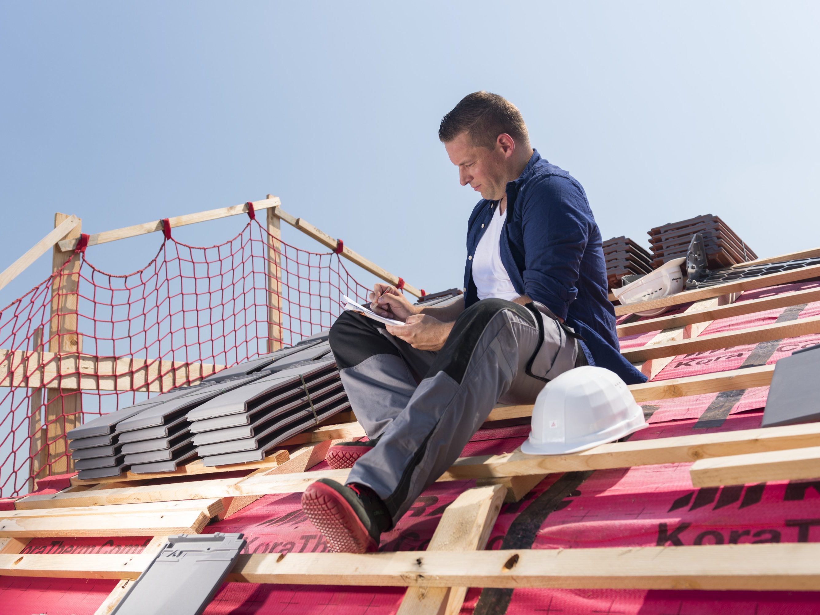 Roofer sitting on timber batten