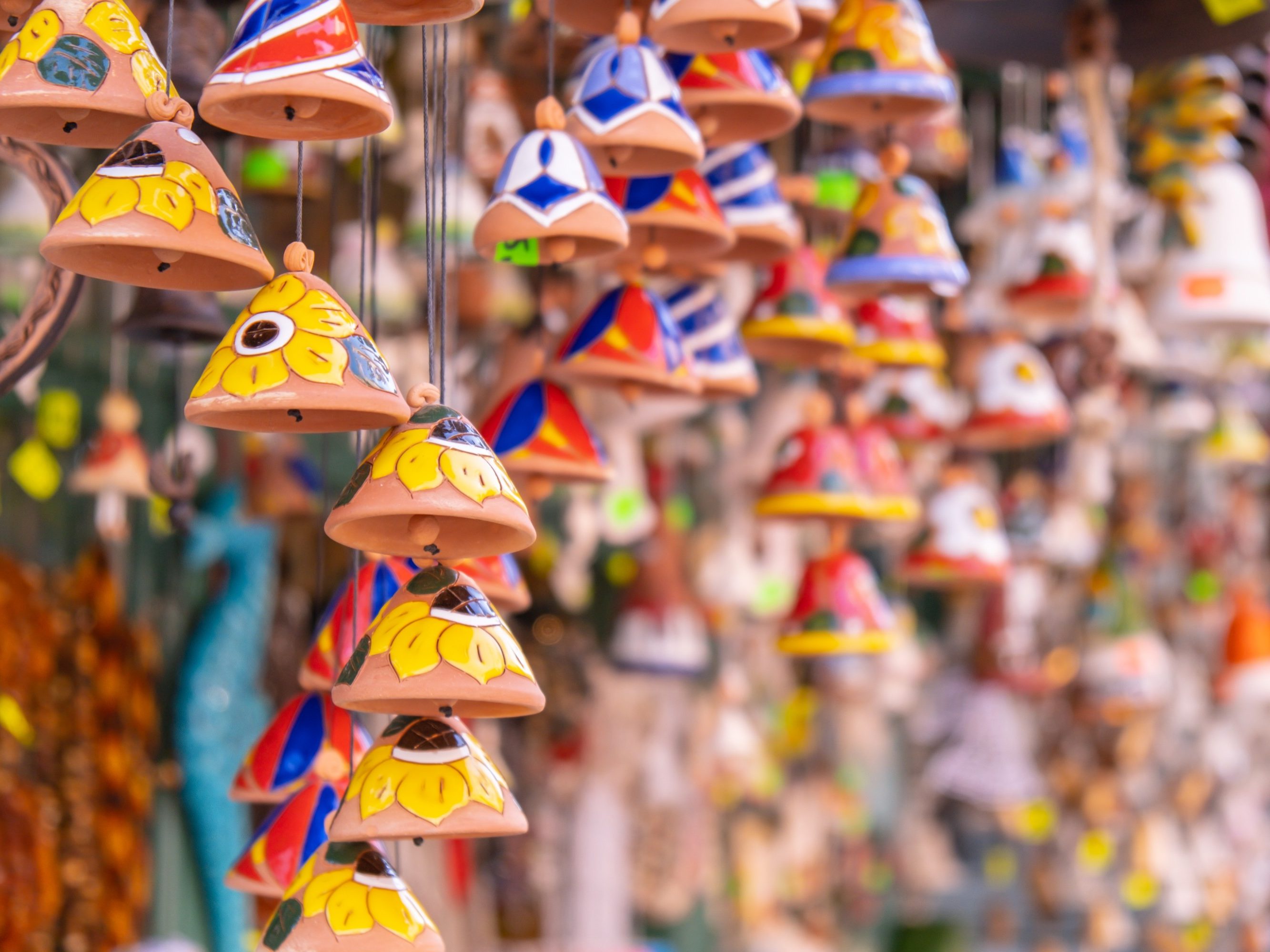 Ceramic handycrafts sold in the shops sold in Sopot Poland. Candid souvenir travel gifts. Clay bells hang on a rope. Shallow depth of field
