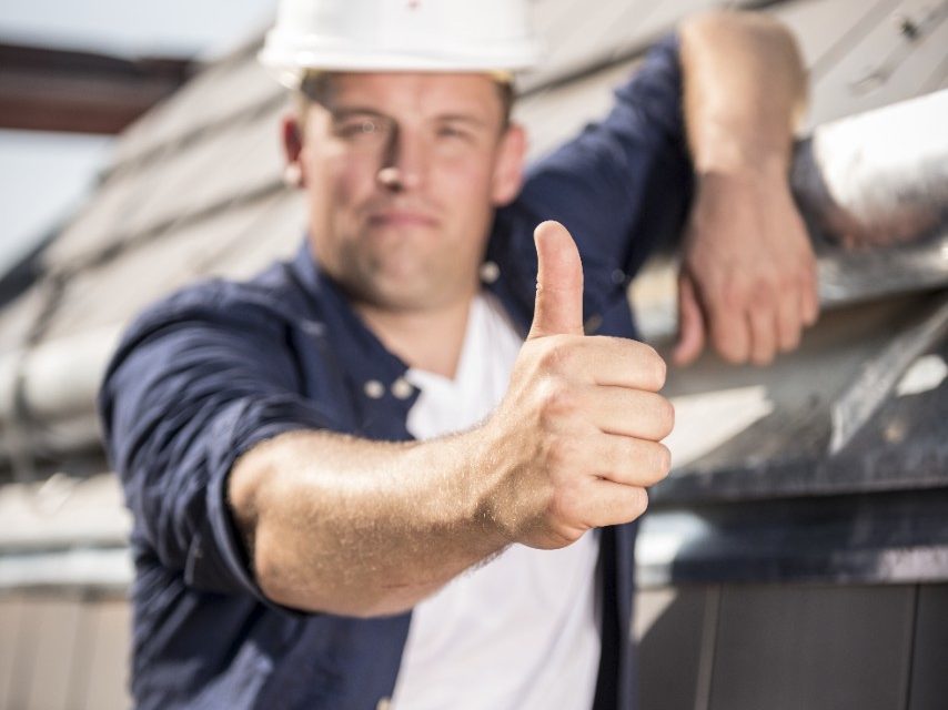 Blurry roofer presenting his crisp thumb 