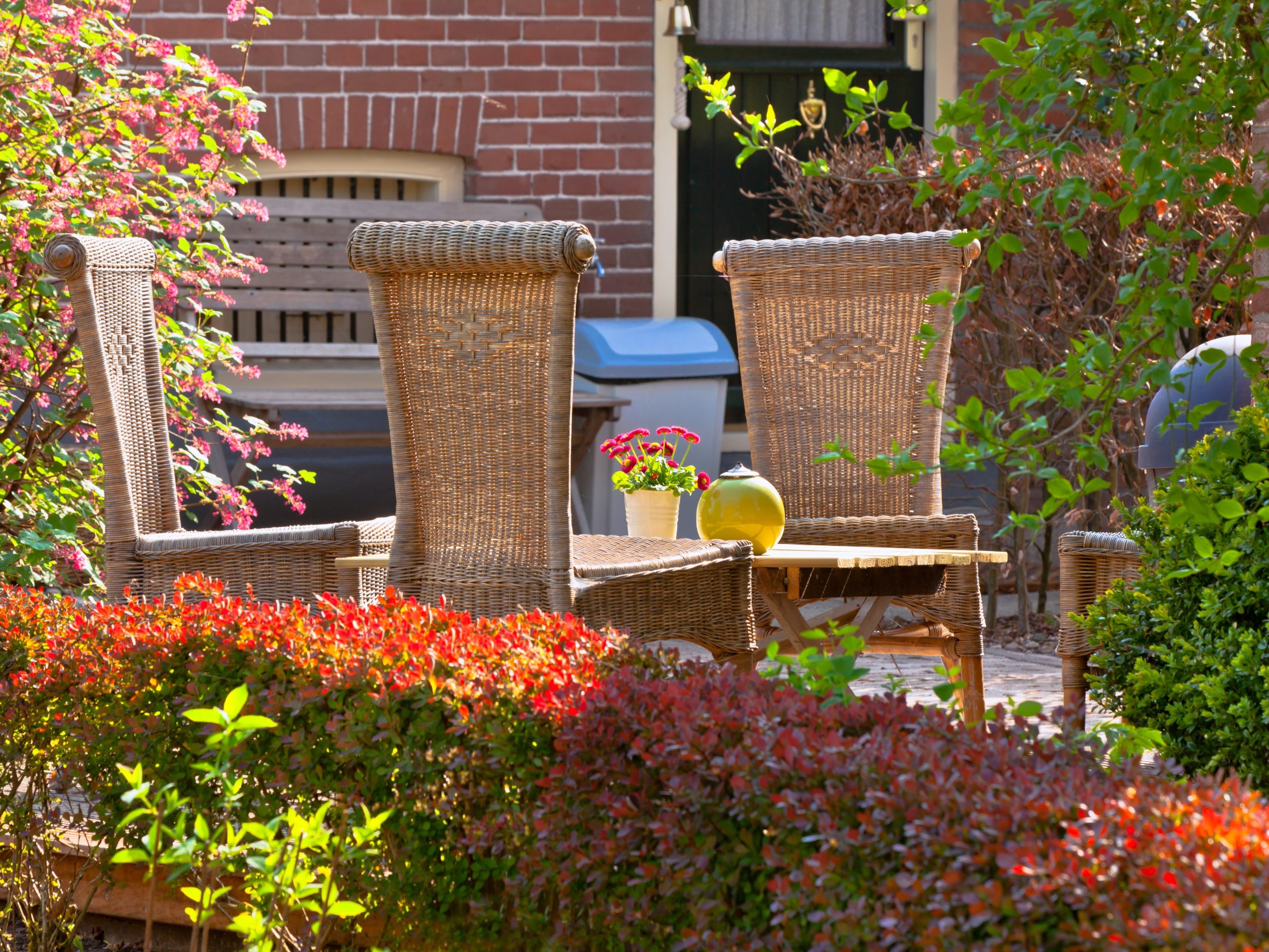 Wicker chairs in the front garden. Very cozy and rustic.