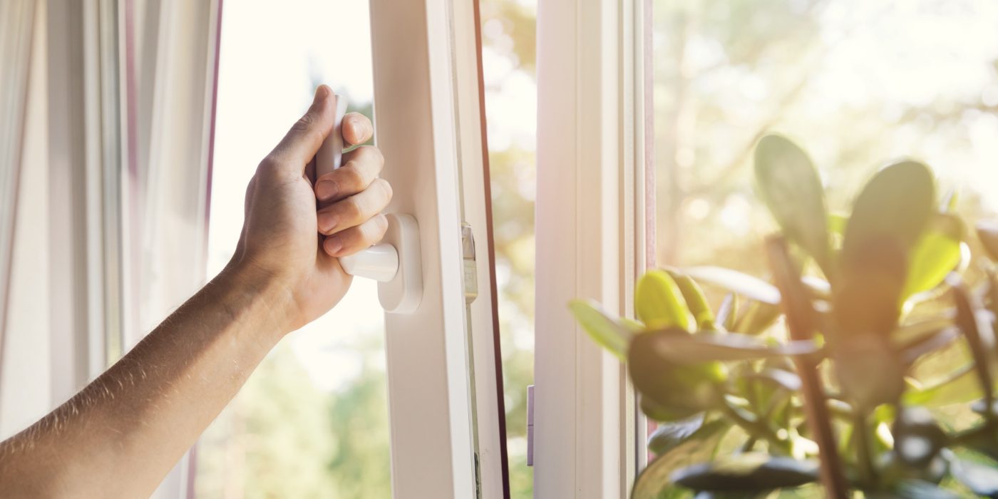 hand open white plastic pvc window at home