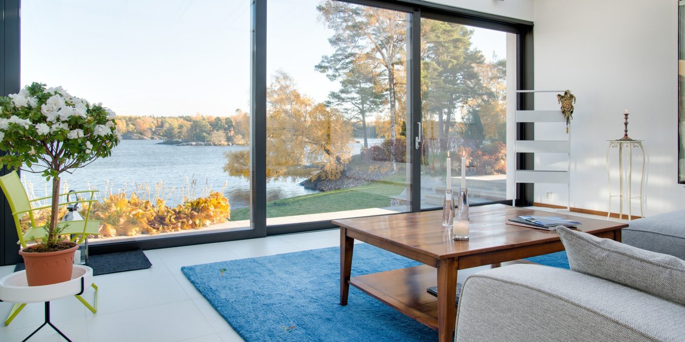 A beautiful view of a blue lake captured from the inside of a villa