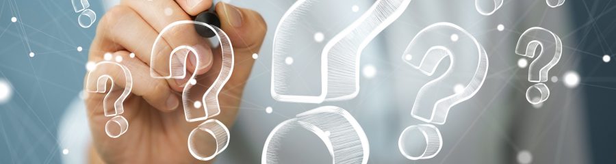 Businesswoman on blurred background drawing hand drawn question marks