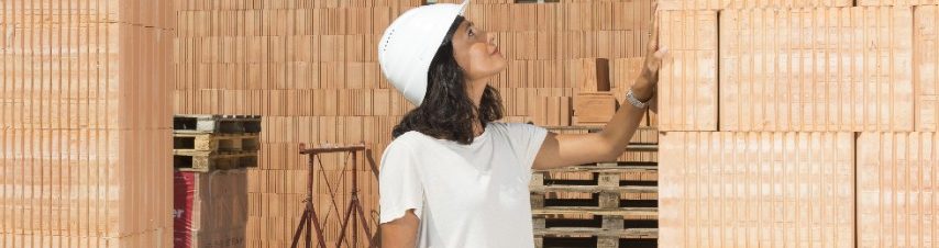 Female architect checking door frame on construction site